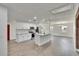 Open concept kitchen featuring white cabinets, stainless steel appliances, marble countertops and a large center island at 3212 Cork Rd, Plant City, FL 33565