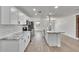 Modern kitchen boasts stainless steel appliances, white cabinets, marble countertops, and breakfast bar at 3212 Cork Rd, Plant City, FL 33565