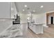 Modern kitchen boasts stainless steel appliances, white cabinets, marble countertops, and breakfast bar at 3212 Cork Rd, Plant City, FL 33565