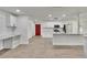 Open concept kitchen featuring white cabinets, stainless steel appliances, marble countertops, and a large island at 3212 Cork Rd, Plant City, FL 33565