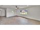 Bright living room featuring wood-look floors, ceiling fan, and bright windows at 3212 Cork Rd, Plant City, FL 33565