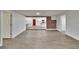 An expansive room featuring light wood flooring, doorways, and a glimpse of the kitchen at 3212 Cork Rd, Plant City, FL 33565