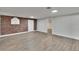 Bright living room features wood floors, a brick wall, and recessed lighting at 3212 Cork Rd, Plant City, FL 33565