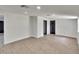 Bright living room with modern flooring, white walls, and freshly painted black doors at 3212 Cork Rd, Plant City, FL 33565