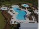 An aerial view of the community amenities, featuring a pool, splash pad, playground, and lounge area perfect for gatherings at 33675 Elm Hill Br, Wesley Chapel, FL 33545
