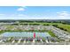 Aerial view of home, showcasing the community, nearby pond, and expansive green fields at 33675 Elm Hill Br, Wesley Chapel, FL 33545