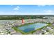 An aerial view of a beautiful home, showcasing the lake view, backyard, and proximity to community amenities at 33675 Elm Hill Br, Wesley Chapel, FL 33545