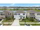 Aerial view of a beautiful home near a tranquil lake, surrounded by other residences at 33675 Elm Hill Br, Wesley Chapel, FL 33545