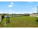 Expansive backyard with a well-maintained lawn and a view of the serene pond at 33675 Elm Hill Br, Wesley Chapel, FL 33545