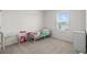 Bright bedroom with a window view, carpet floors, and room for a desk at 33675 Elm Hill Br, Wesley Chapel, FL 33545
