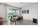The dining area with sliding glass doors leading to a patio overlooking the lake at 33675 Elm Hill Br, Wesley Chapel, FL 33545