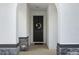 Inviting entryway featuring a stylish front door with a wreath and elegant stone accents at 33675 Elm Hill Br, Wesley Chapel, FL 33545