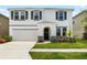 Charming two-story home with a well-manicured lawn and a two-car garage at 33675 Elm Hill Br, Wesley Chapel, FL 33545
