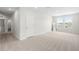 Large main bedroom with lots of natural light, neutral carpeting, and a view of the outdoors at 33675 Elm Hill Br, Wesley Chapel, FL 33545