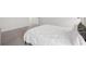 Carpeted main bedroom with a plush white comforter on the bed at 33675 Elm Hill Br, Wesley Chapel, FL 33545