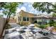 Spacious backyard featuring a checkered patio, covered seating area, and mature trees at 3611 W Bay To Bay Blvd, Tampa, FL 33611