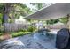 Serene backyard featuring a covered patio, outdoor seating, and a charming fence at 3611 W Bay To Bay Blvd, Tampa, FL 33611
