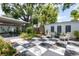 Backyard oasis with a checkered patio, lounge chairs, and well-maintained landscaping at 3611 W Bay To Bay Blvd, Tampa, FL 33611