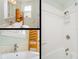 Bright bathroom with modern fixtures, wooden shelving, and a shower with tiled walls at 3611 W Bay To Bay Blvd, Tampa, FL 33611
