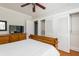 Well-lit bedroom with a ceiling fan, closet with bi-fold doors, and an adjacent TV on a dresser at 3611 W Bay To Bay Blvd, Tampa, FL 33611