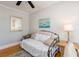 Cozy bedroom featuring hardwood floors, neutral walls, and a comfortable daybed with decorative pillows at 3611 W Bay To Bay Blvd, Tampa, FL 33611