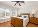 Cozy bedroom featuring hardwood floors, large windows, and a beautifully crafted wooden bed frame at 3611 W Bay To Bay Blvd, Tampa, FL 33611