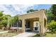 Single-story house featuring a stucco exterior, a practical carport, and verdant landscaping at 3611 W Bay To Bay Blvd, Tampa, FL 33611