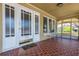 Charming front porch featuring tiled floors, white trim, and an adjacent seating area with natural light at 3611 W Bay To Bay Blvd, Tampa, FL 33611