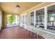 Inviting front porch featuring tile floors, an adjacent seating area, and sunlit windows with bright light at 3611 W Bay To Bay Blvd, Tampa, FL 33611