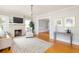 Comfortable living room featuring hardwood floors, a decorative fireplace, and neutral paint colors at 3611 W Bay To Bay Blvd, Tampa, FL 33611