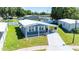 Bird's-eye view highlighting the home's carport, surrounding landscape, and neighborhood layout at 36435 Bonney Dr, Zephyrhills, FL 33541