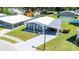 Aerial shot showcases this beautiful home with well-kept lawn, covered parking, and proximity to community features at 36435 Bonney Dr, Zephyrhills, FL 33541