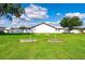 Expansive backyard featuring lush green grass under a bright blue sky with scattered cumulus clouds at 36435 Bonney Dr, Zephyrhills, FL 33541