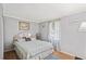 Cozy bedroom features neutral paint, wood floors and light-filled window at 36435 Bonney Dr, Zephyrhills, FL 33541