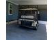 This carport features a golf cart and a covered area at 36435 Bonney Dr, Zephyrhills, FL 33541