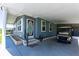 Covered parking area leading to the home's entrance, with visible landscaping and convenient access at 36435 Bonney Dr, Zephyrhills, FL 33541