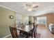 Spacious dining area with a large table, abundant natural light, and cozy atmosphere at 36435 Bonney Dr, Zephyrhills, FL 33541