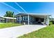 Welcoming single-Gathering home features a convenient covered parking area and manicured lawn with a street address at 36435 Bonney Dr, Zephyrhills, FL 33541