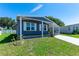 Quaint home with a carport, neatly landscaped lawn, and ample natural light streaming through the windows at 36435 Bonney Dr, Zephyrhills, FL 33541
