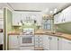 Bright kitchen featuring white cabinetry, wood countertops, and appliances at 36435 Bonney Dr, Zephyrhills, FL 33541