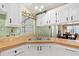 Kitchen view highlighting wood countertops, white cabinets, and a double sink at 36435 Bonney Dr, Zephyrhills, FL 33541