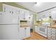 Functional kitchen with white appliances, plenty of storage, and wood-style flooring at 36435 Bonney Dr, Zephyrhills, FL 33541