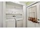 Laundry room features washer, dryer, shelving, and storage space at 36435 Bonney Dr, Zephyrhills, FL 33541