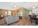 Open-concept living area with wood floors flowing into a dining and kitchen area at 36435 Bonney Dr, Zephyrhills, FL 33541