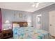 Bedroom featuring a cozy bed, side tables with lamps, and a view into the bathroom at 36435 Bonney Dr, Zephyrhills, FL 33541