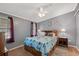 Comfortable bedroom with a patterned quilt, side tables, and good natural light at 36435 Bonney Dr, Zephyrhills, FL 33541