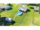 Aerial view of fenced backyard with pool and shed, plus home and surrounding landscape at 37113 Waldo Dr, Dade City, FL 33525