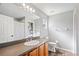 Well-lit bathroom featuring a vanity with wood cabinets, a mirror, and a shower at 37113 Waldo Dr, Dade City, FL 33525