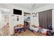 Bedroom with a wall mounted TV, closet, shelves, and wood laminate floors at 37113 Waldo Dr, Dade City, FL 33525