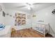 bedroom showcasing a crib, themed decor, and wood-look flooring at 37113 Waldo Dr, Dade City, FL 33525